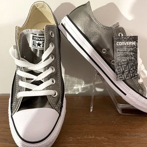 Never worn. New with tags no box. Shimmery Silver Converse slip on sneakers.